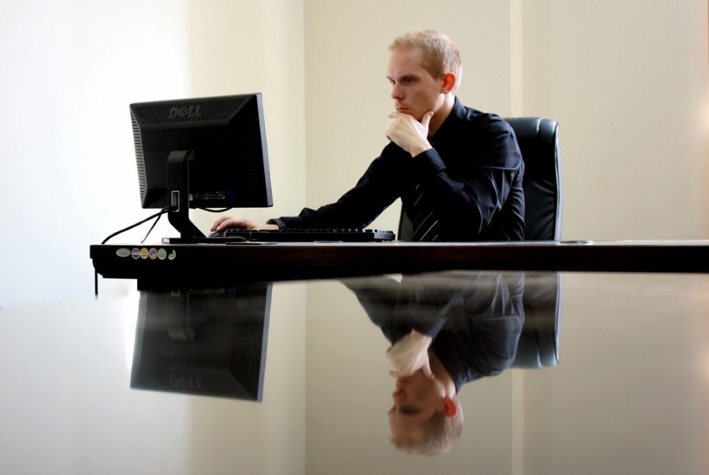 person at a desk on a computer